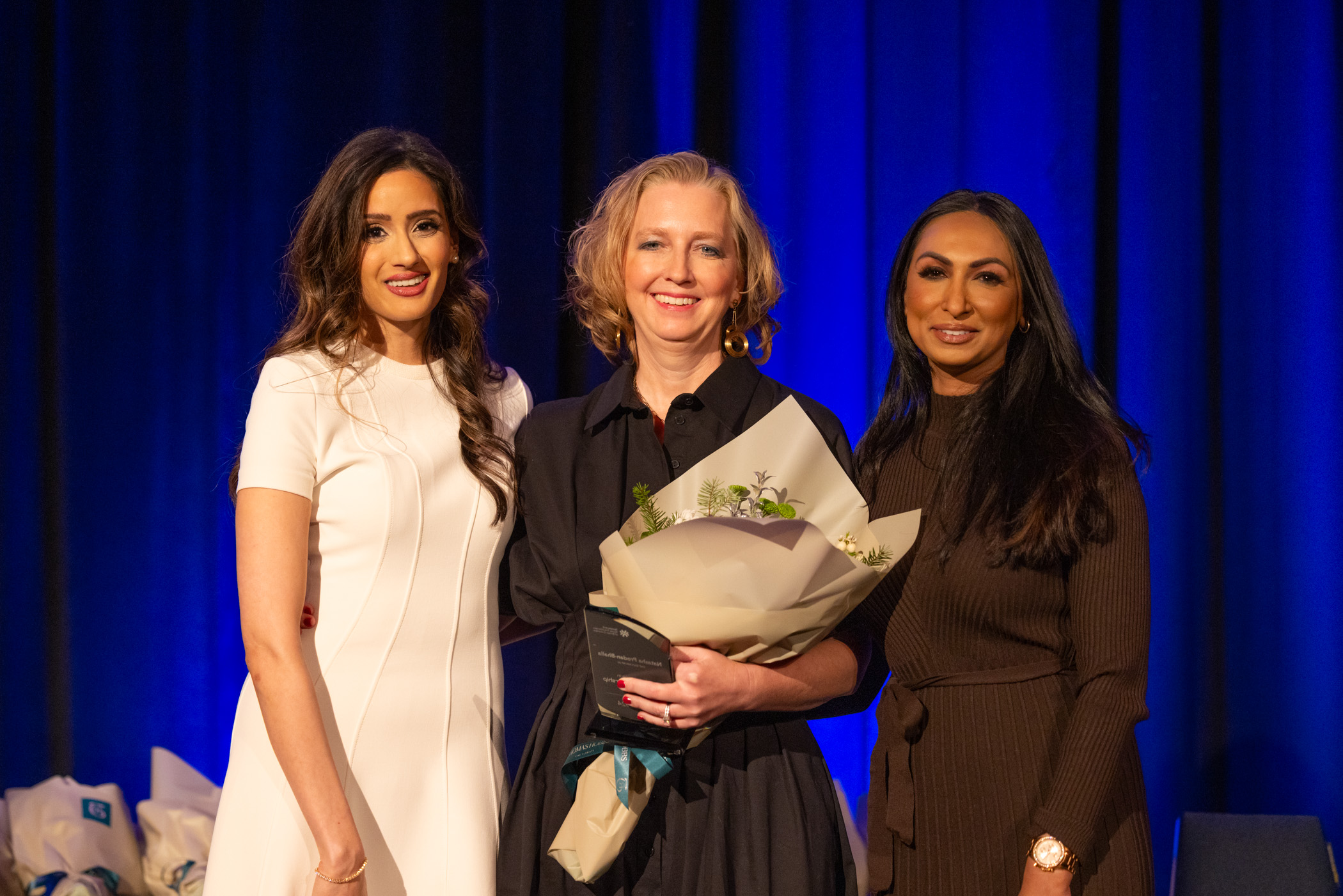 Dr. Natasha Prodan-Bhalla accepts the 2024 Excellence in Nursing Leadership, posing with NNPBC board members, Sukhi and Jane